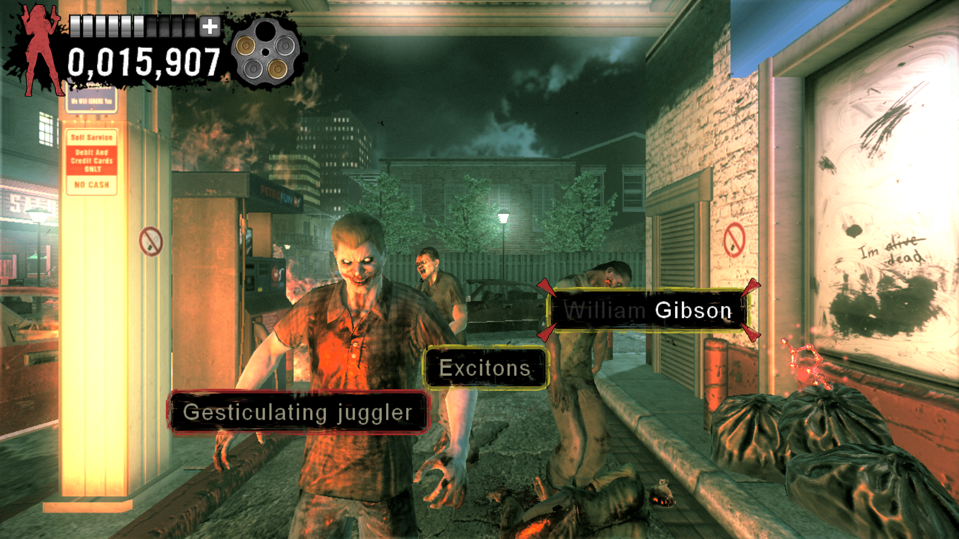 captura de tela do jogo The Typing of The Dead: Overkill (PC, 2013). Visão em primeira pessoa, o cenário é um posto de gasolina, com três zumbis (ou melhor, mutantes! Não pronuncie a Z-word!), cada um deles tem uma caixa de texto que deve ser digitado para eliminá-los. Da esquerda para direita: "Gesticulating juggler", "Excitons" e "William Gibson" (com o primeiro nome já digitado e com fonte escurecida). Na parede, há uma frase "I'm alive" com a palavra "alive" riscada e "dead" escrita abaixo dela.